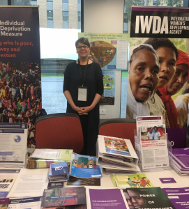 Jo stands in front of two banners, one for the IDM, one for IDWA, with several brochures and print outs of studies.
