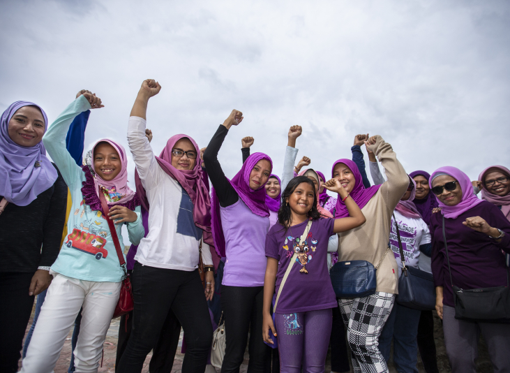 Group of woman stand with fists raised
